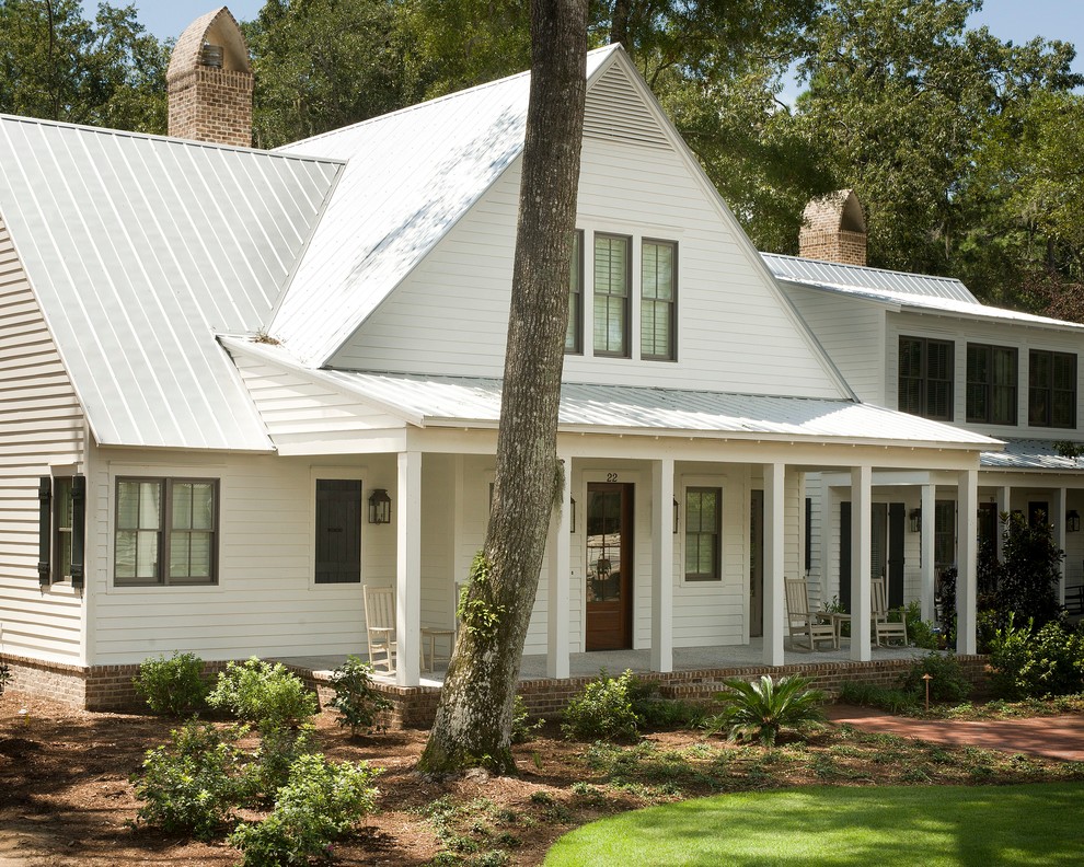 This is an example of a white farmhouse two floor house exterior in Atlanta with concrete fibreboard cladding.