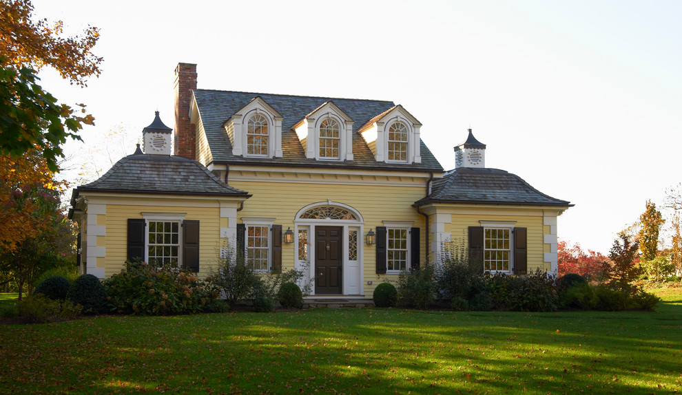 Design ideas for a yellow traditional house exterior in New York.
