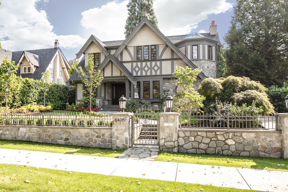 Example of a classic two-story mixed siding exterior home design in Vancouver with a mixed material roof