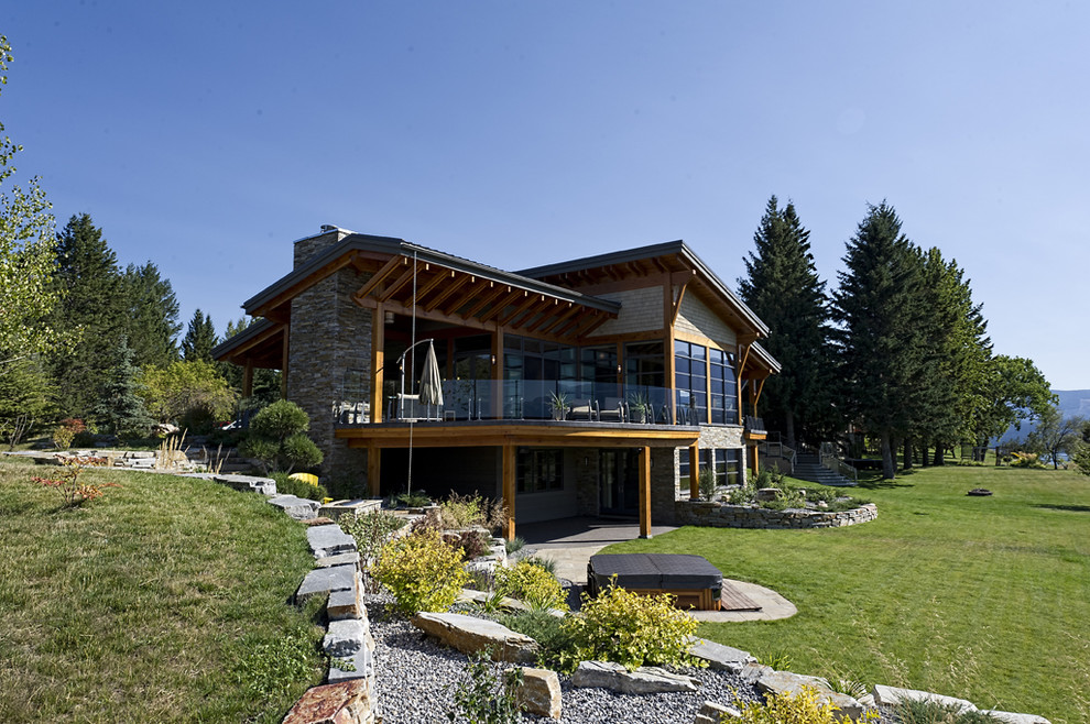 Huge mountain style gray two-story mixed siding house exterior photo in Vancouver with a shed roof and a metal roof