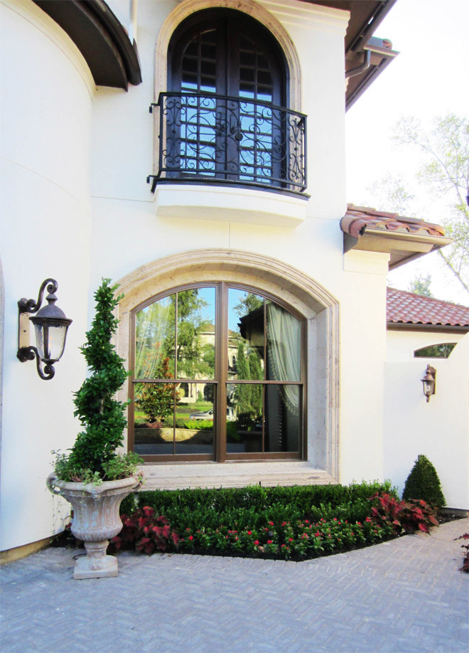 Mid-sized tuscan white two-story stucco exterior home photo in Houston with a tile roof