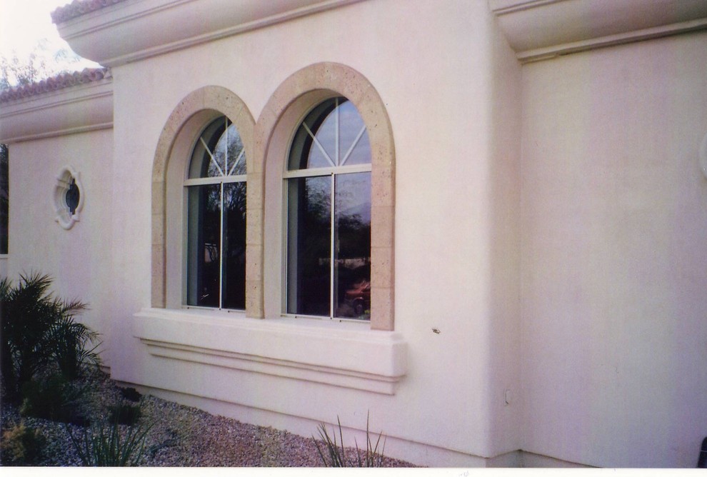This is an example of a small mediterranean two floor render house exterior in Phoenix.