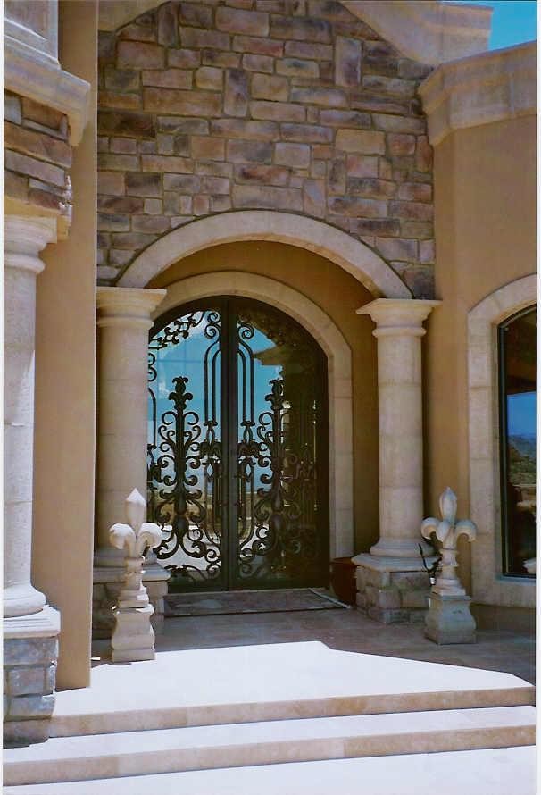 Inspiration for a large mediterranean beige two-story stucco exterior home remodel in Phoenix