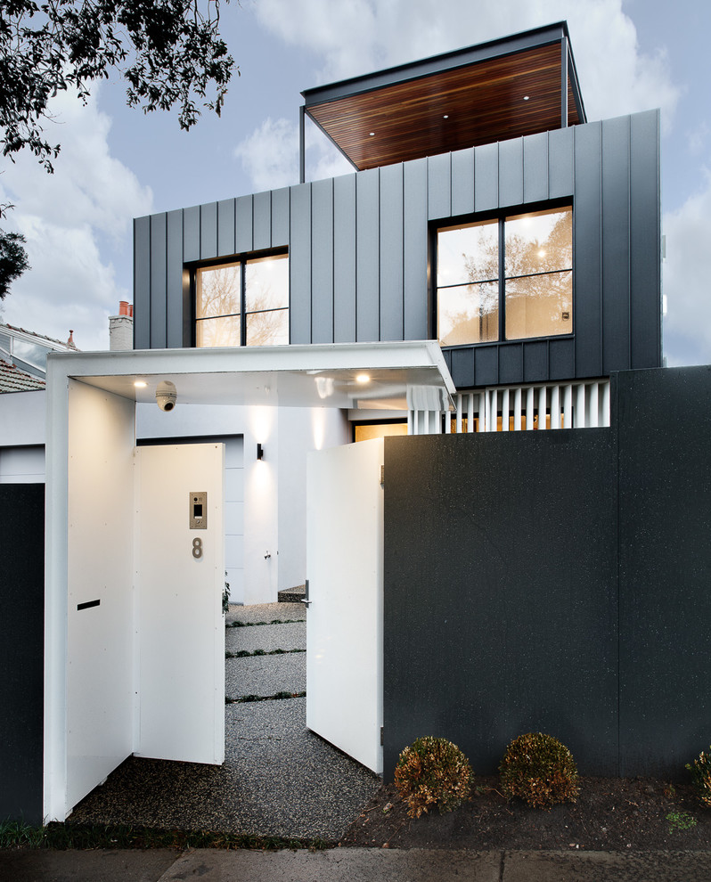 Inspiration for a large and gey contemporary detached house in Melbourne with three floors, metal cladding, a flat roof and a metal roof.