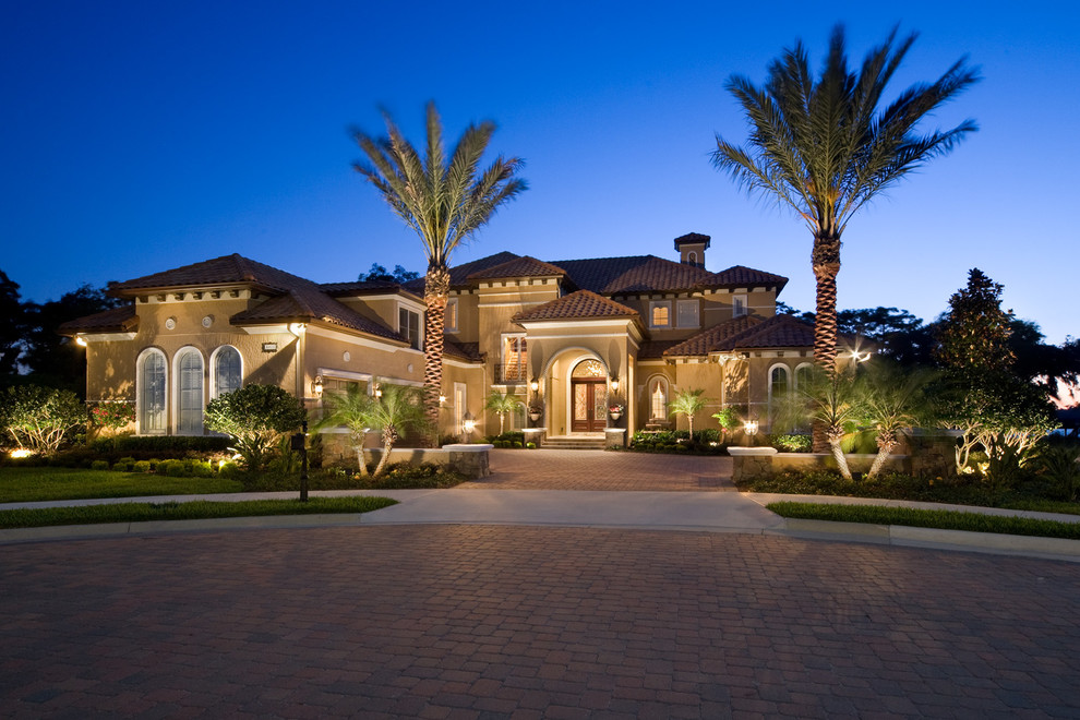 Inspiration for a large mediterranean two-story exterior home remodel in Orlando