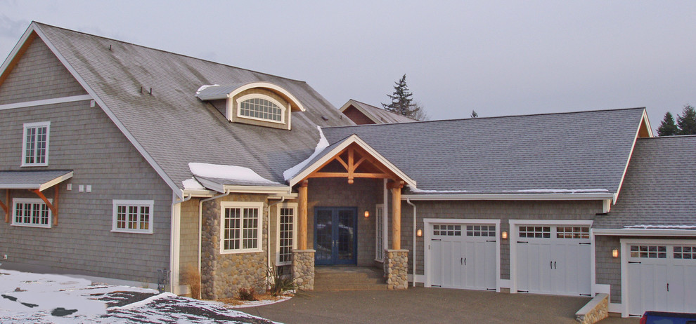 Example of a mid-sized mountain style gray two-story wood exterior home design in Seattle