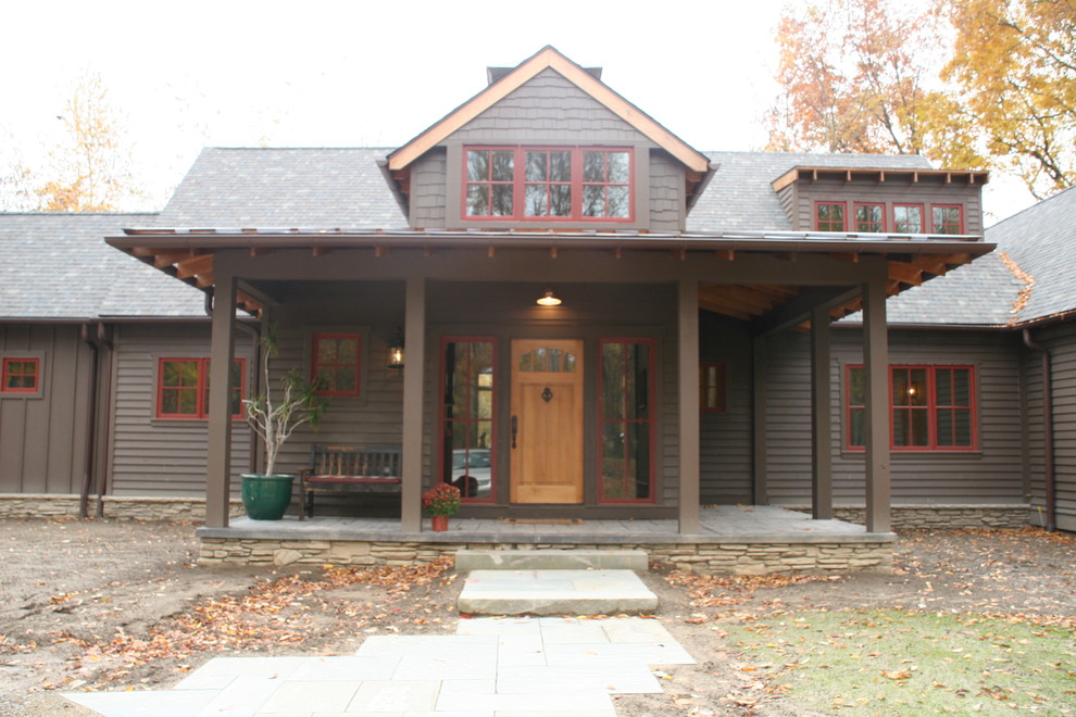Inspiration for a large and brown classic two floor house exterior in Detroit with wood cladding and a pitched roof.