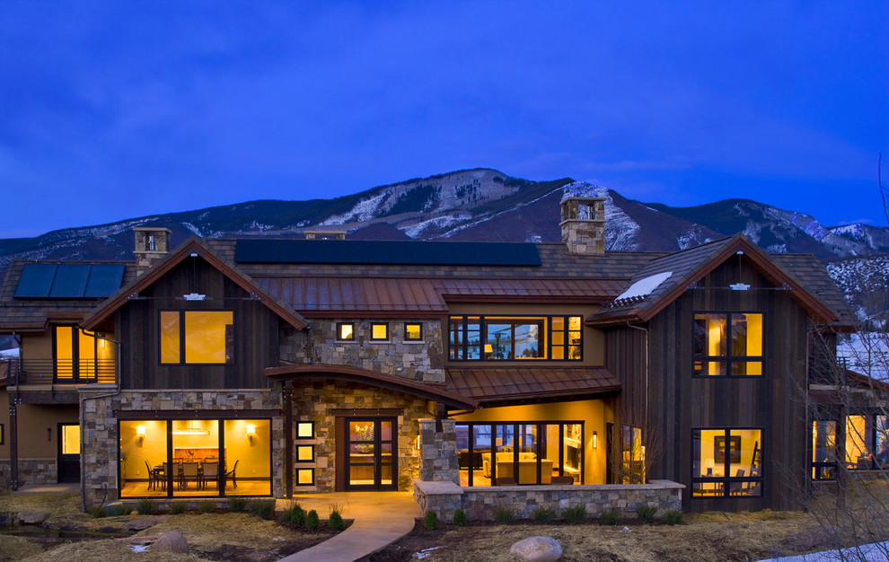 Photo of a large rustic two floor house exterior in Denver with mixed cladding.