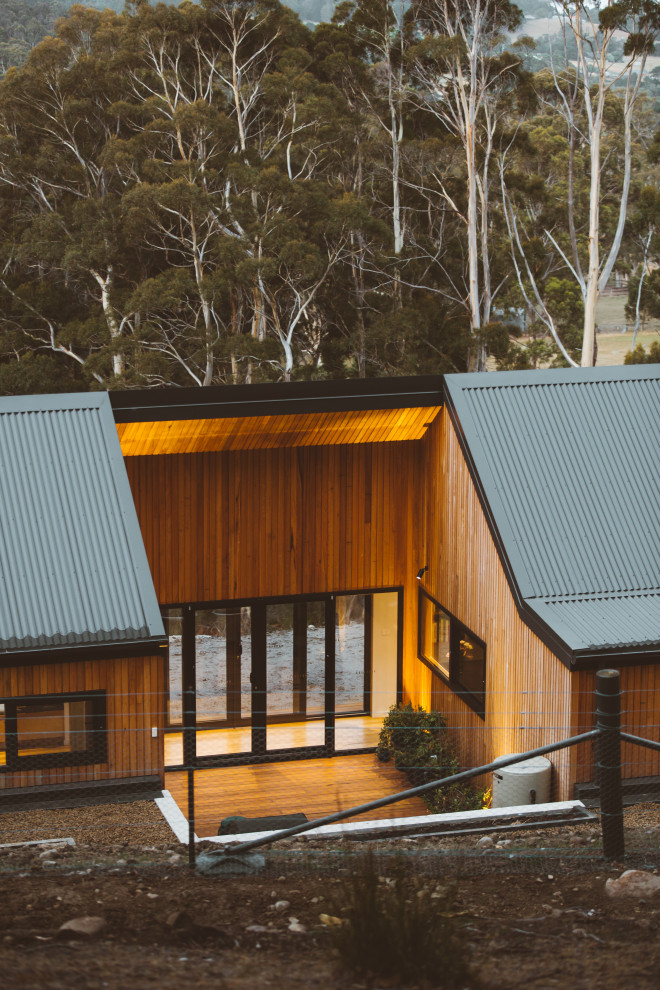 Contemporary detached house in Hobart with wood cladding and a metal roof.