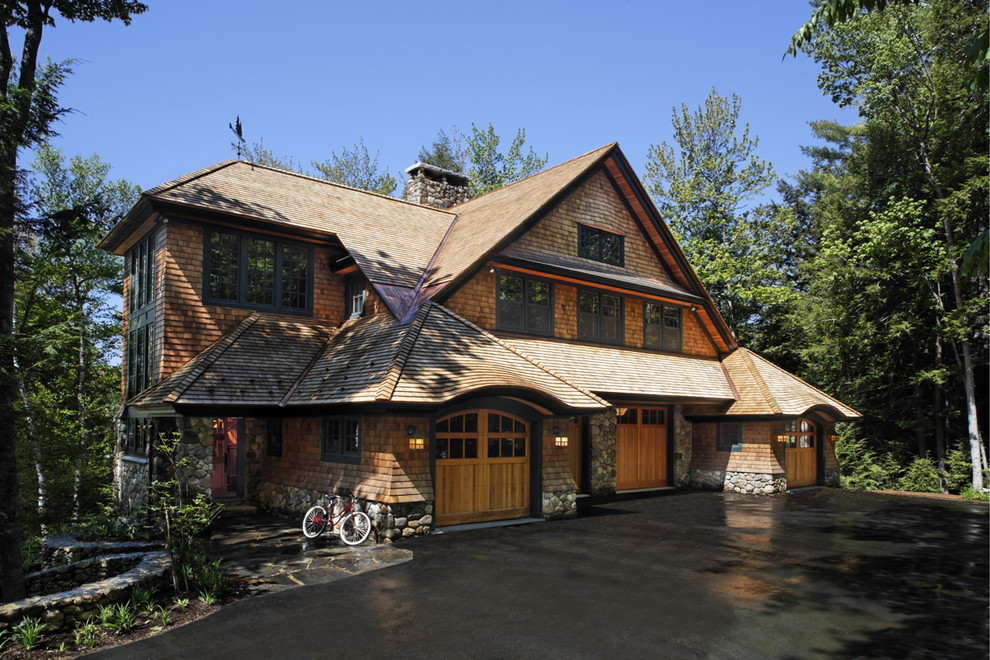 Inspiration for a rustic two floor house exterior in Boston with wood cladding.