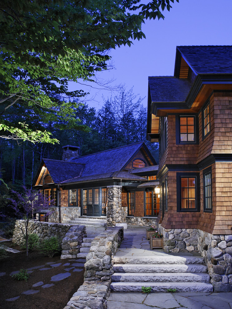 Design ideas for a rustic house exterior in Boston with wood cladding.