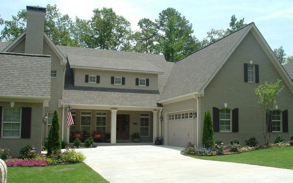Example of a classic beige two-story brick exterior home design in Little Rock