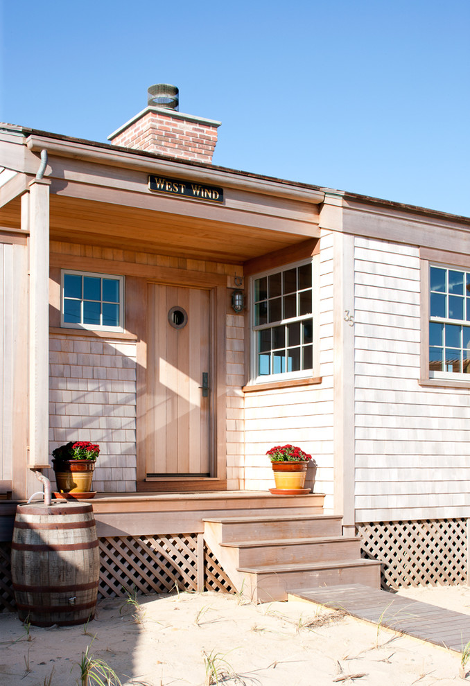 Small nautical bungalow house exterior in Boston with wood cladding.