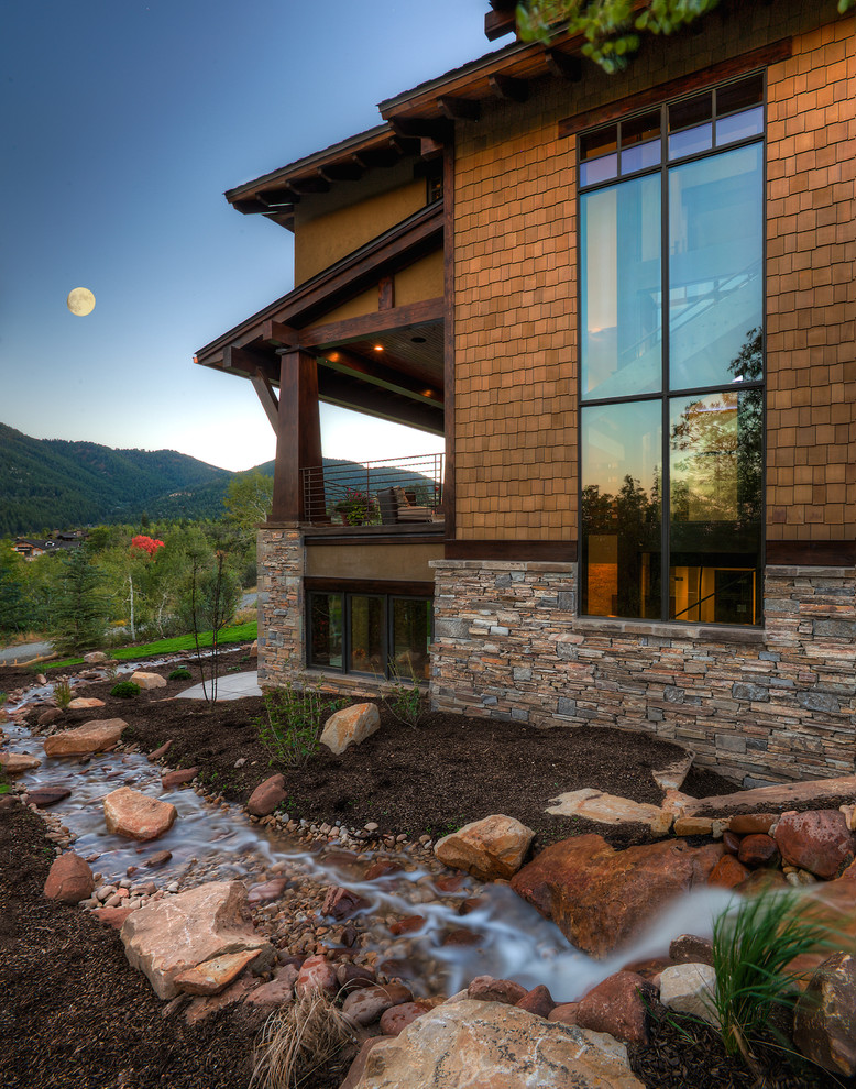 Inspiration for an expansive and brown world-inspired house exterior in Salt Lake City with mixed cladding.