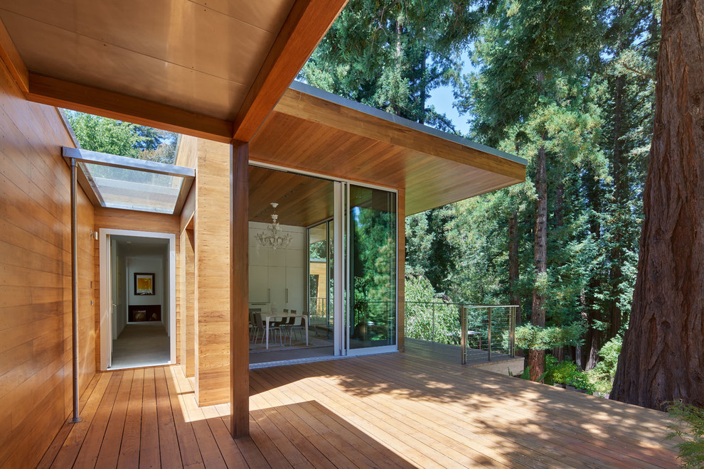 Inspiration for a small modern brown one-story wood exterior home remodel in San Francisco with a mixed material roof