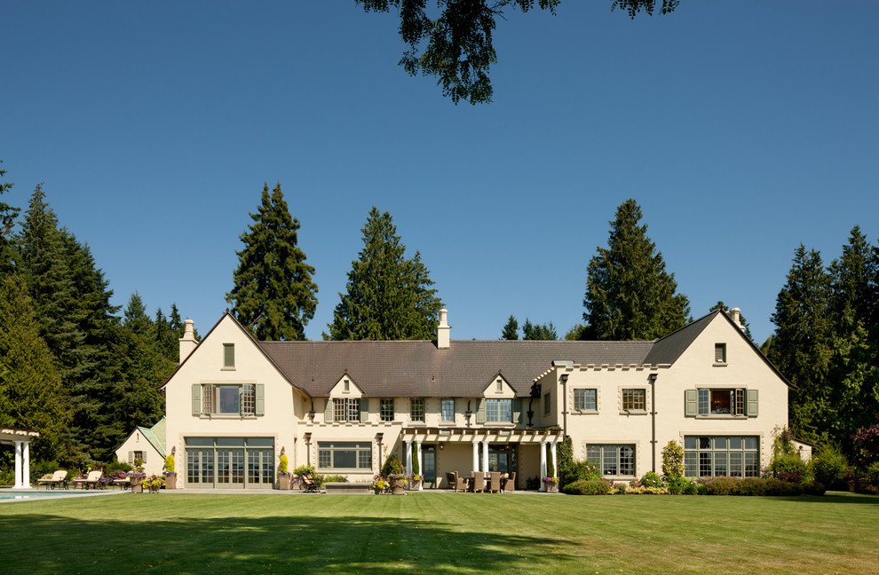 Inspiration for a huge timeless three-story stucco exterior home remodel in Seattle