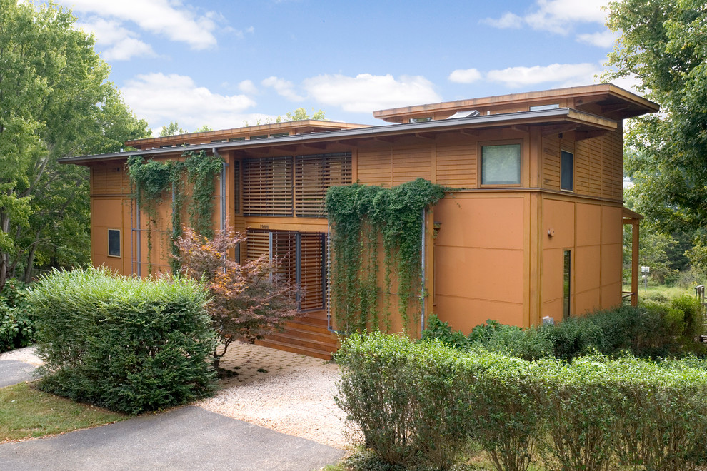 Стильный дизайн: маленький, двухэтажный, коричневый дом в стиле модернизм с облицовкой из ЦСП для на участке и в саду - последний тренд