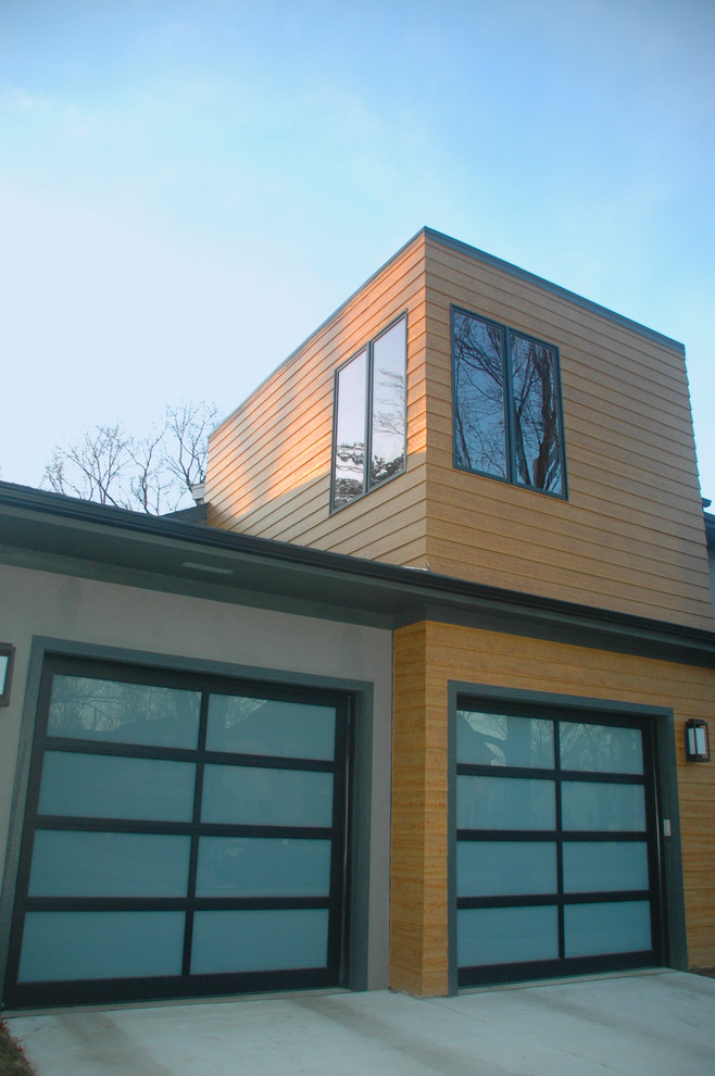 На фото: большой, двухэтажный, коричневый частный загородный дом в стиле модернизм с облицовкой из ЦСП, плоской крышей и металлической крышей с