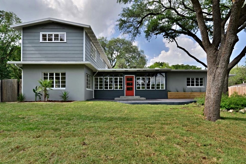 Design ideas for a gey retro two floor house exterior in Austin with mixed cladding.