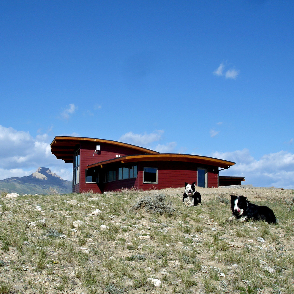 This is an example of a red and large contemporary two floor house exterior in San Francisco with wood cladding and a lean-to roof.