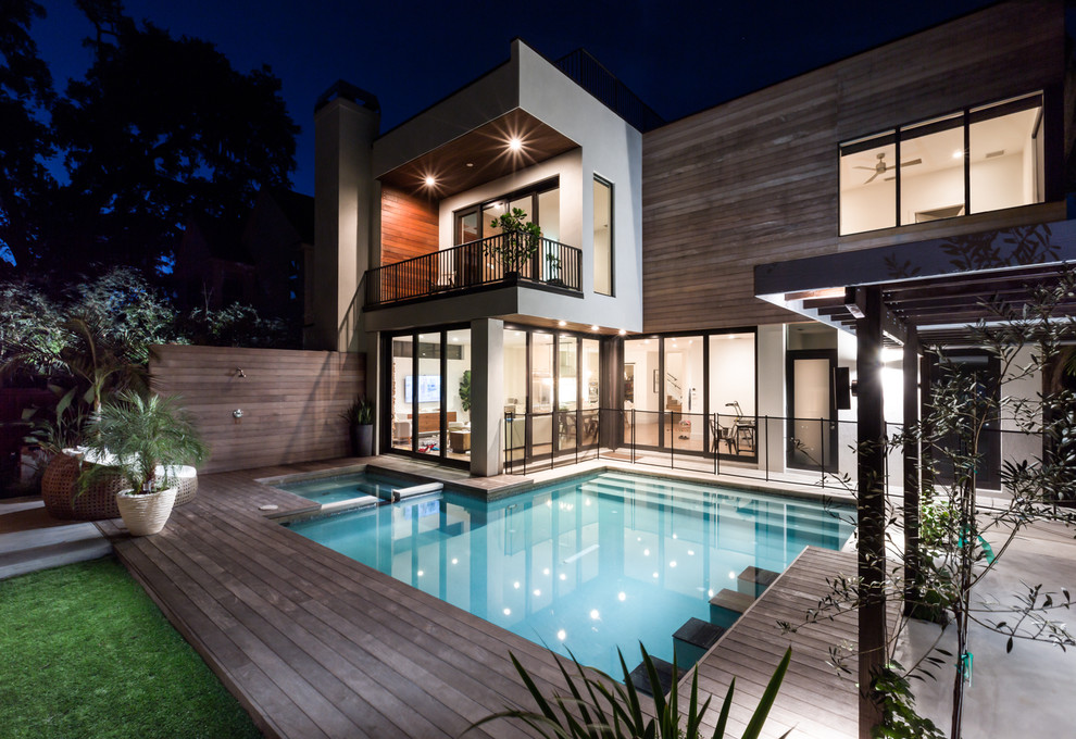 Inspiration for a large and white modern house exterior in Austin with three floors, wood cladding and a flat roof.