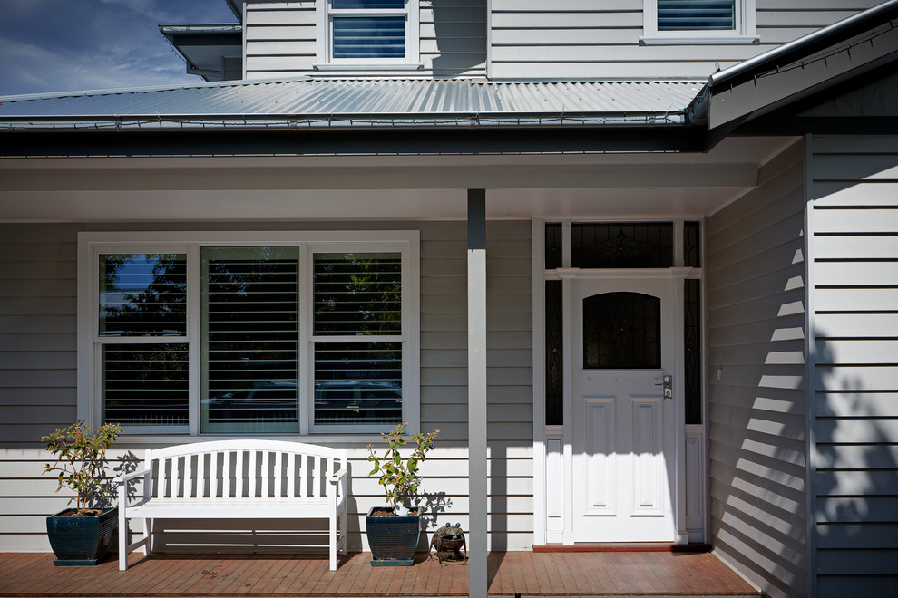 Large and gey classic two floor house exterior in Melbourne with wood cladding.