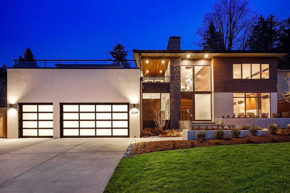 Inspiration for a contemporary two-story mixed siding flat roof remodel in Seattle