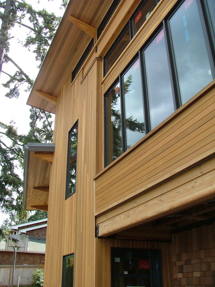 This is an example of a large and brown modern two floor house exterior in Seattle with wood cladding.