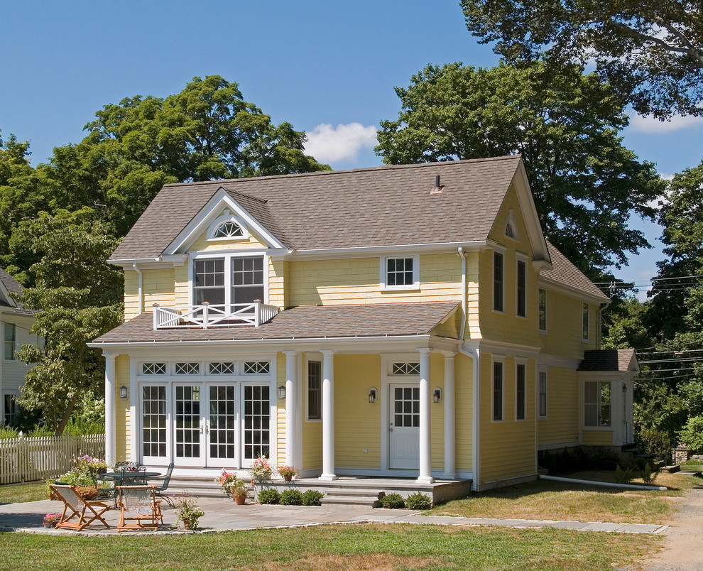 Example of a mid-sized classic yellow two-story wood exterior home design in New York
