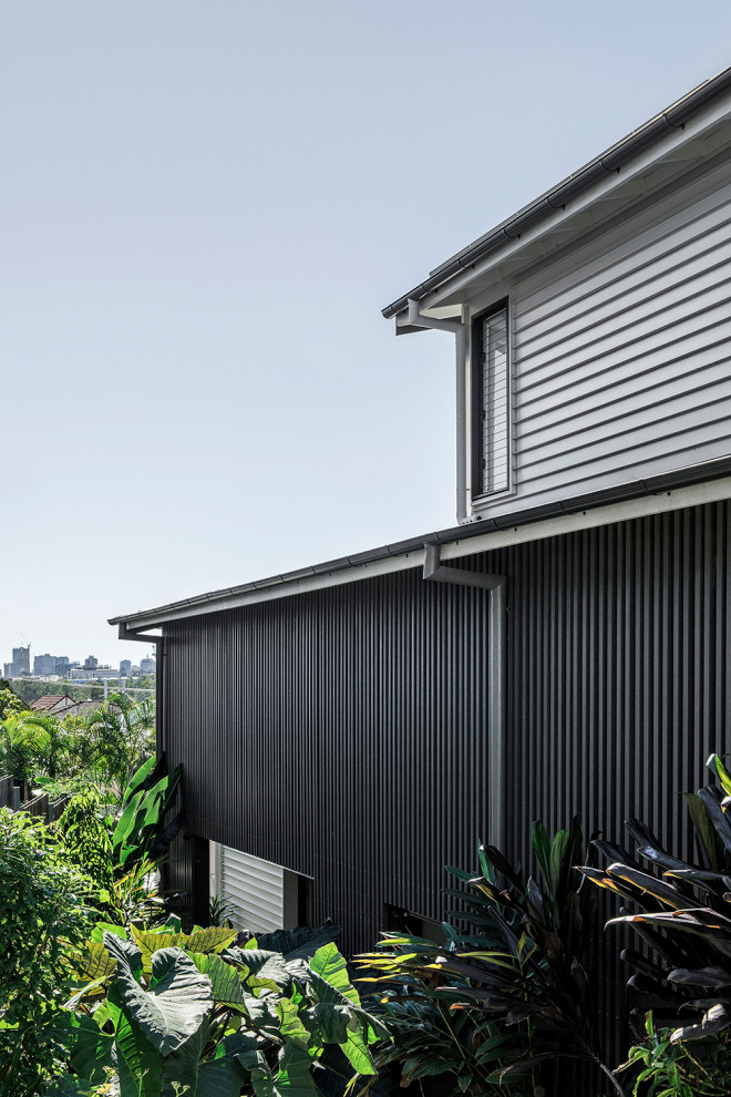 Design ideas for a large and white contemporary split-level detached house in Brisbane with metal cladding, a pitched roof and a metal roof.