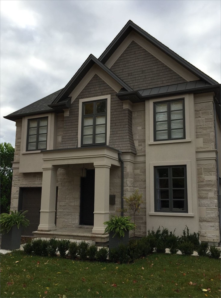 Inspiration for a medium sized and beige classic two floor detached house in Toronto with stone cladding, a pitched roof and a shingle roof.