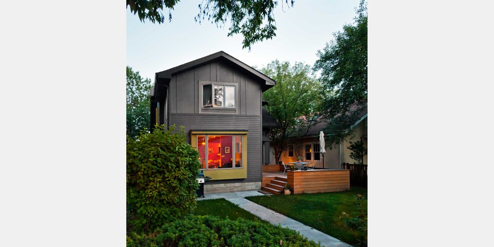 Inspiration for a small eclectic green two-story stucco exterior home remodel in Minneapolis