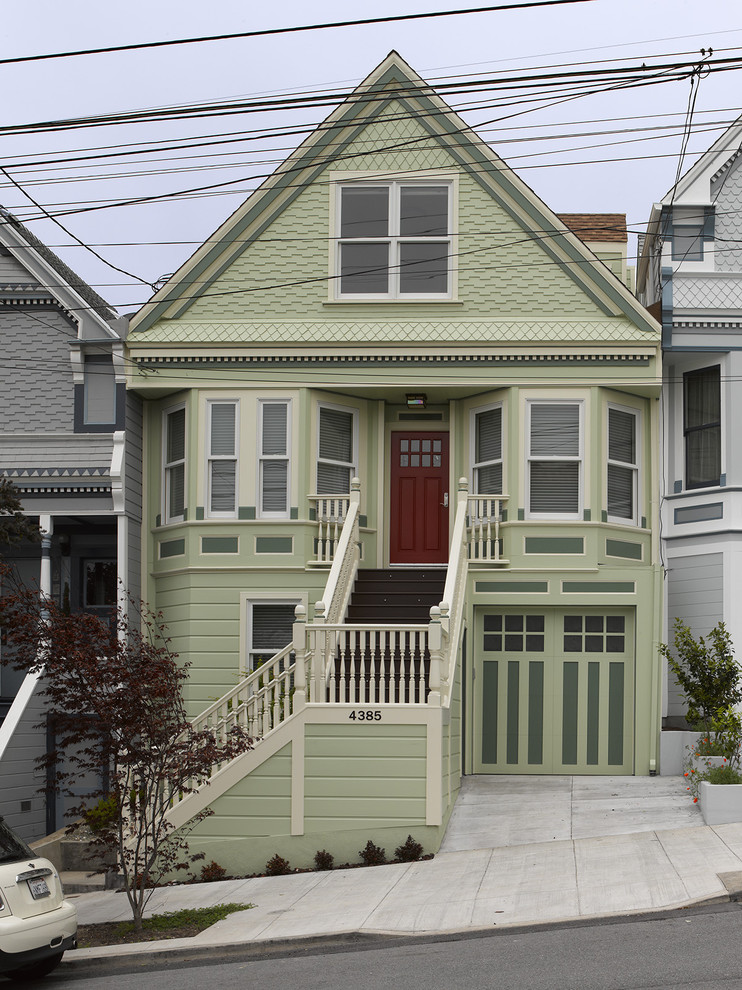 Mid-sized ornate green two-story wood exterior home photo in San Francisco with a shingle roof