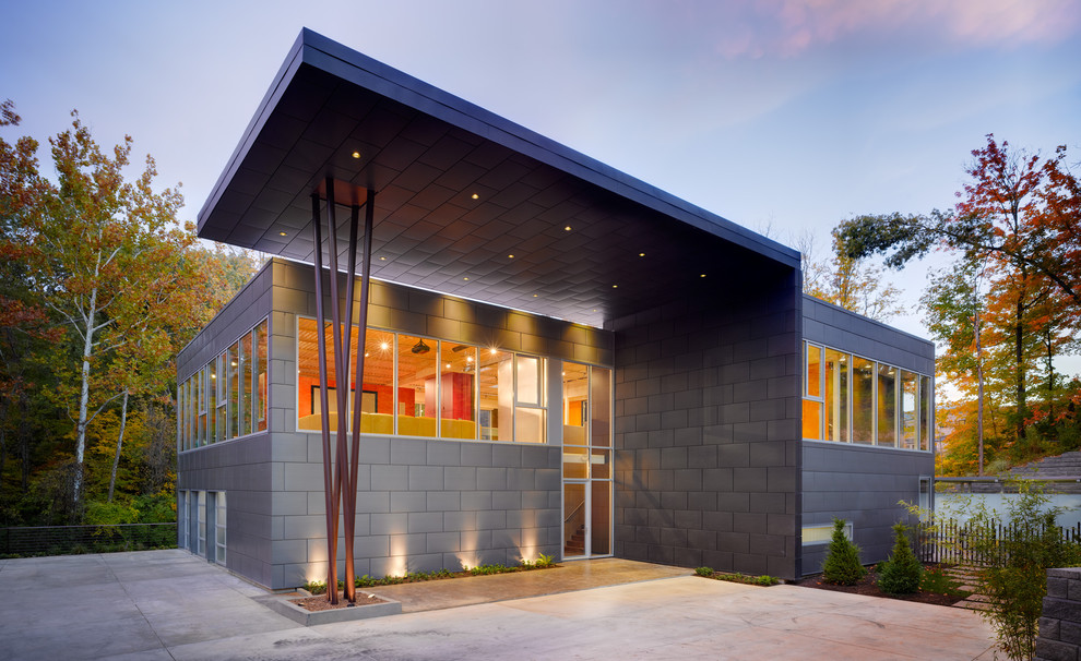 Diseño de fachada gris industrial con revestimiento de metal y tejado plano