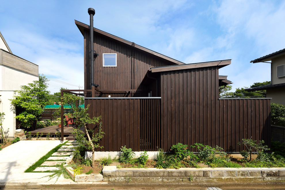 Photo of a small and brown rustic two floor detached house in Tokyo Suburbs with wood cladding and a metal roof.