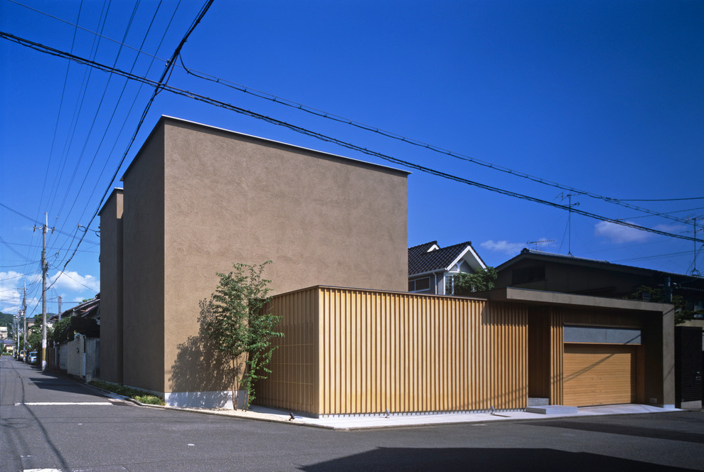 Asiatisches Haus mit brauner Fassadenfarbe und Flachdach in Kyoto