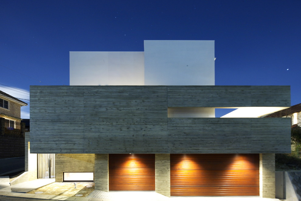 Ejemplo de fachada contemporánea de tres plantas con tejado plano