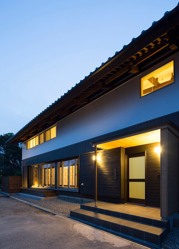 Large traditional two floor detached house in Other with a pitched roof and a tiled roof.