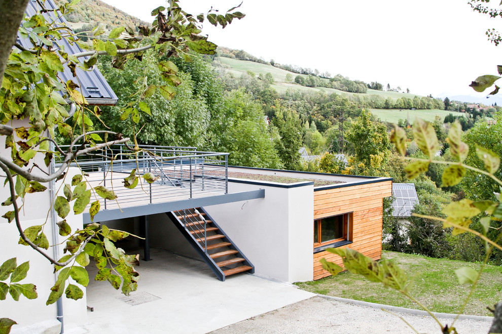 Modelo de fachada contemporánea de tamaño medio de dos plantas con revestimiento de madera, tejado a dos aguas y escaleras