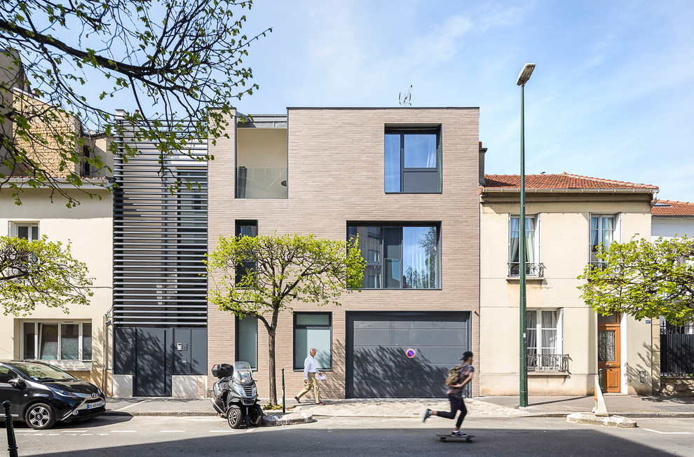 Example of a large urban brown three-story brick exterior home design in Paris
