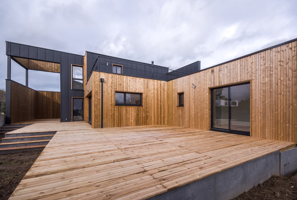 Inspiration for a large coastal black two-story metal exterior home remodel in Rennes with a mixed material roof
