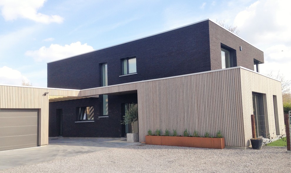 Inspiration for a large contemporary black two-story brick exterior home remodel in Lille