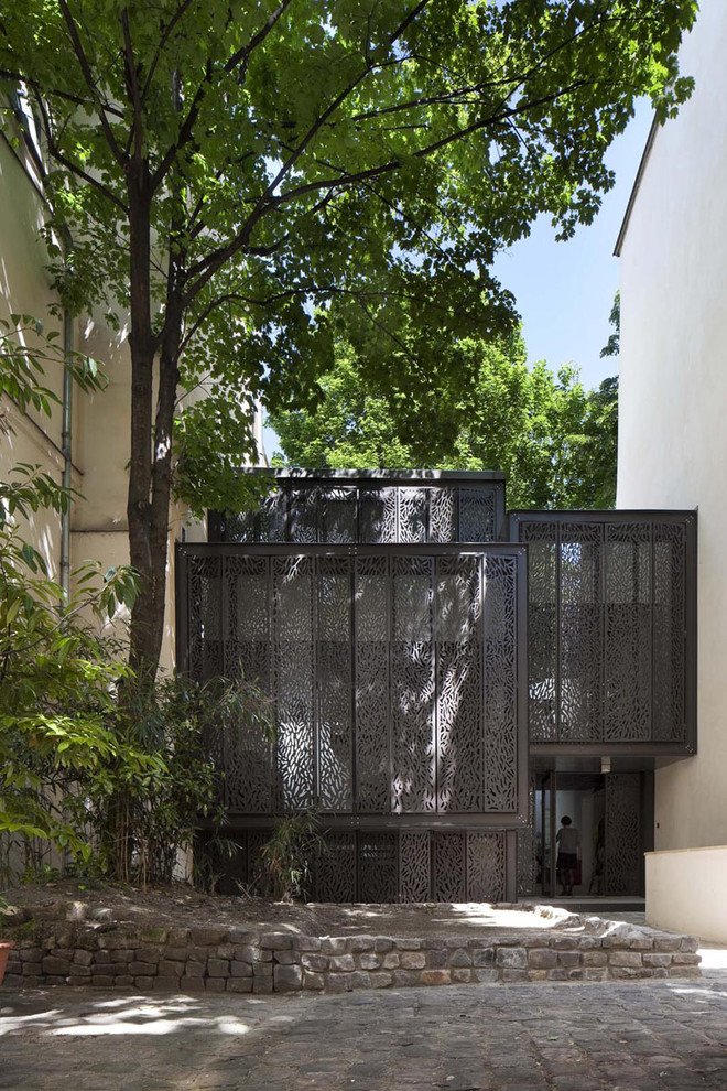 Inspiration for a mid-sized contemporary gray two-story metal flat roof remodel in Other