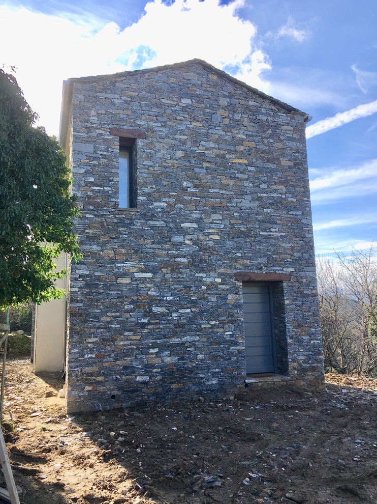 Design ideas for a medium sized and white mediterranean two floor detached house in Corsica with stone cladding, a pitched roof and a shingle roof.