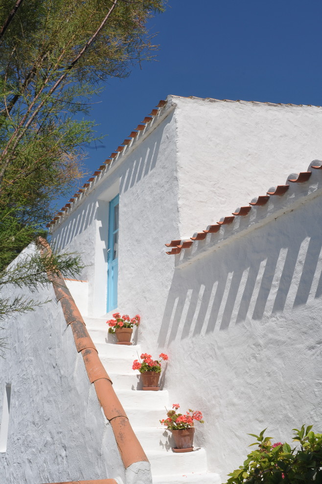 Immagine della facciata di una casa bianca mediterranea a due piani di medie dimensioni con tetto piano