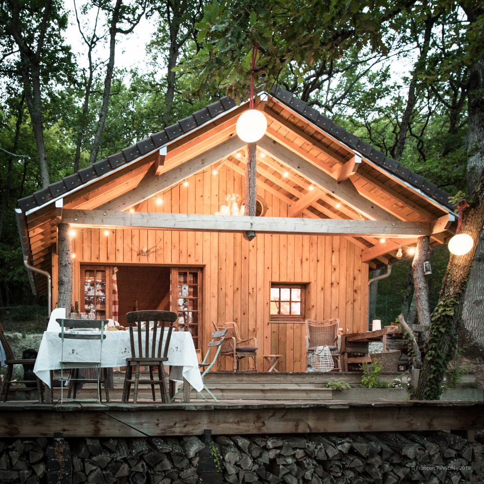 Cette photo montre une petite façade de Tiny House nature en bois à un étage avec un toit à deux pans et un toit noir.
