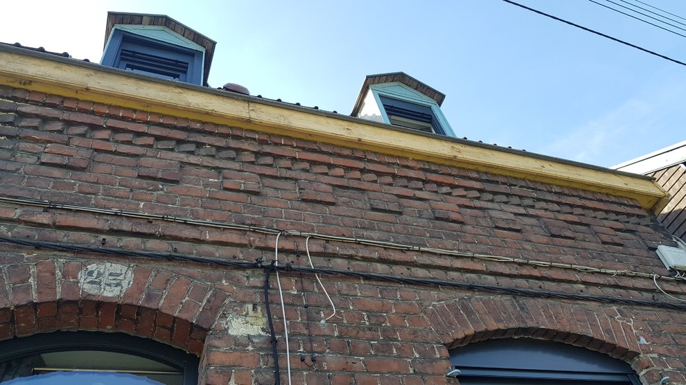 Inspiration for a small and red modern two floor brick terraced house in Lille with a pitched roof and a tiled roof.