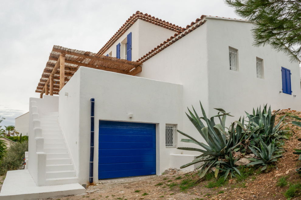 Inspiration for a white beach style detached house in Marseille with three floors, a hip roof and a tiled roof.