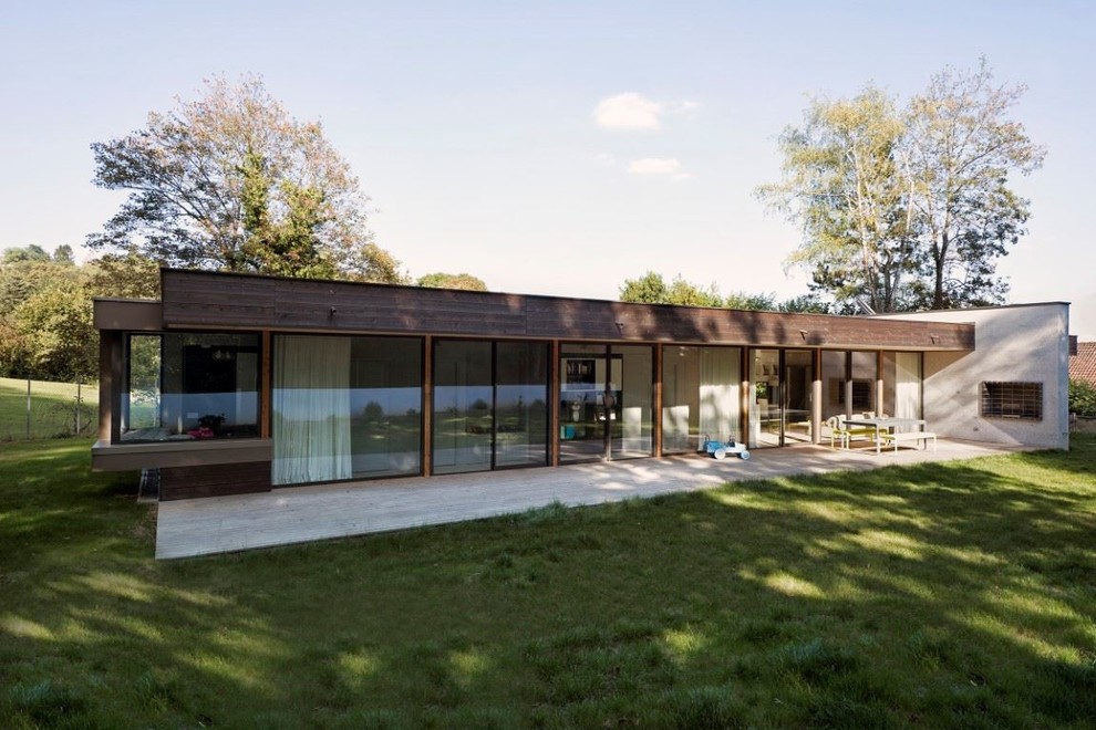 Idee per la villa grande marrone contemporanea a un piano con rivestimento in legno, tetto piano, copertura verde, tetto nero e pannelli sovrapposti