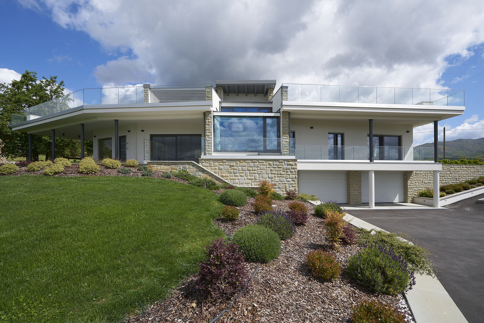 Zweistöckiges Modernes Einfamilienhaus mit Putzfassade und weißer Fassadenfarbe